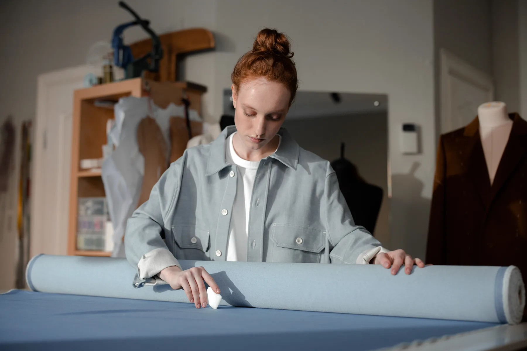 Fashion atelier process with fabric and design work in progress.